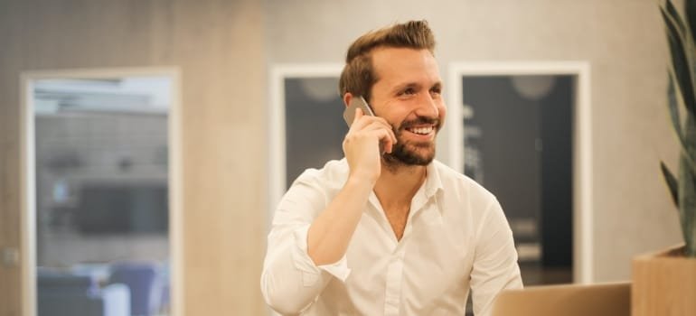 a man on the phone explaining how to find out the cost of a local move in Dover 