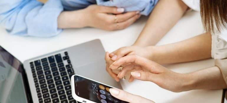 Two women planning their move, as doing research is the best way to estimate the cost of your Somersworth relocation.