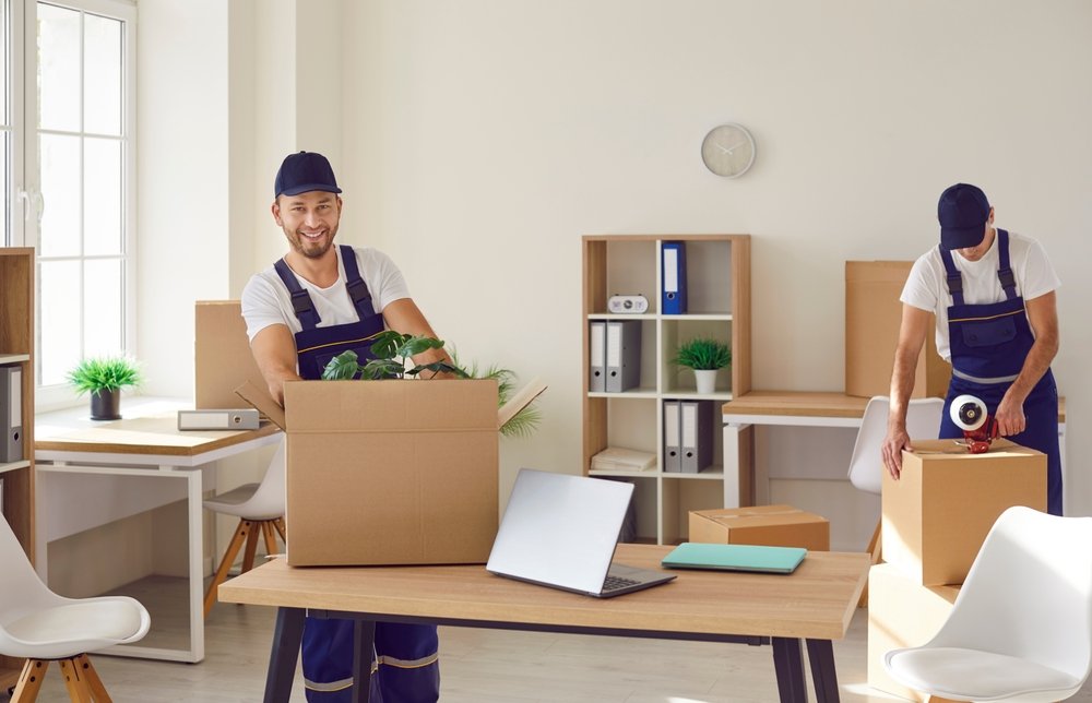 commercial-moving-services-two-man-workers-putting-items-in-boxes
